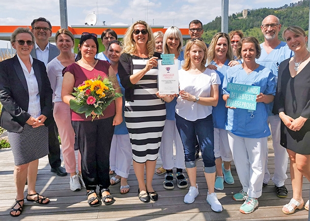 Strahlende Sieger: Die Kinderonkologie Station E130 hat erneut den Landessieg bei „Deutschlands beliebteste Pflegeprofis“ nach Jena geholt (links im Bild: Pflegedirektorin des UKJ, Evelyn Voigt und PKV-Pflegegeschäftsführer Andreas Besche, rechts im Bild Mutter Kristin Grundler, die das Team nominiert hat).