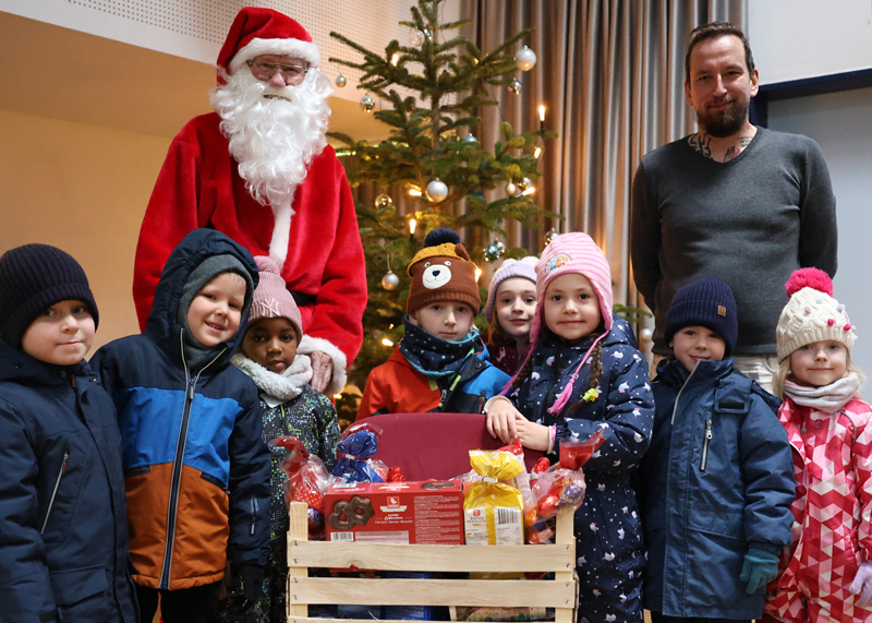 Zur traditionellen Kinderweihnachtsfeier verteilte der Weihnachtsmann (alias Volker Blumentritt) Kisten vollgepackt mit allem, was das Kinderherz begehrt. Hier die Kinder der Kita „Arche Noah“ mit ihren Erzieher Sandro Spreitzer.