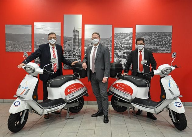 Die Sparkassen-Vorstandsmitglieder Thomas Schütze, Michael Rabich  (Vorsitzender) und Thomas Neupert  freuen sich über zwei neue E-Roller im Fuhrpark.