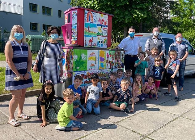 Dezernent Benjamin Koppe, Vertreter/innen der Stadt und der Kita Bertolla freuen sich gemeinsam mit den Kindern über das frische Design.